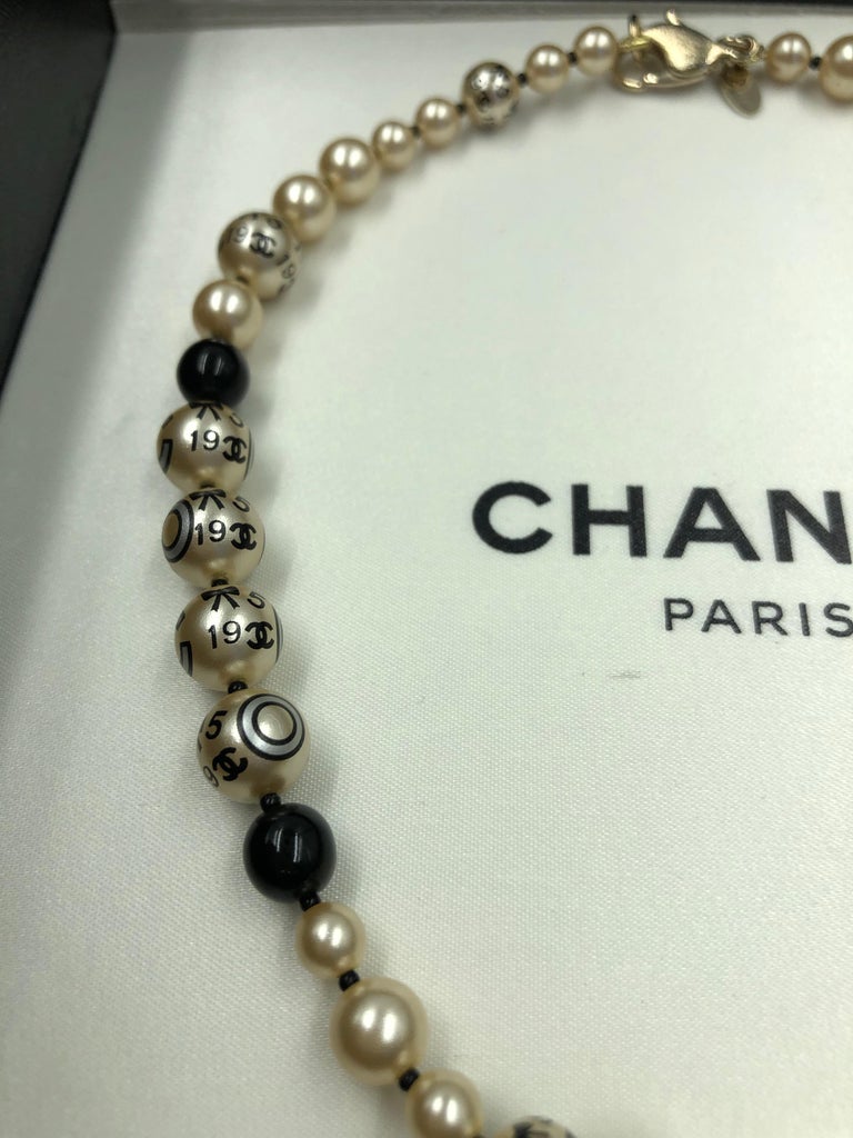 Chanel 1990's Faux Pearls with Coco Chanel Print on Strand