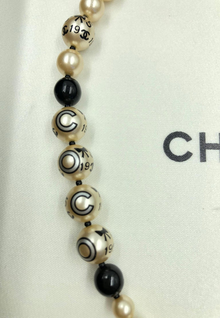 Chanel 1990's Faux Pearls with Coco Chanel Print on Strand