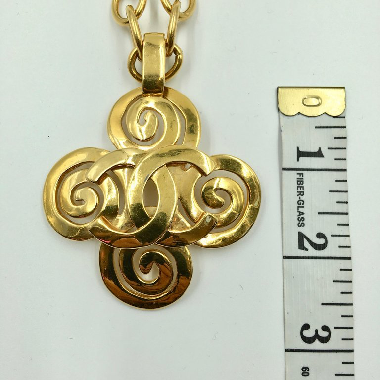 Chanel Gold Tone CC Logo Swirl Cross Necklace