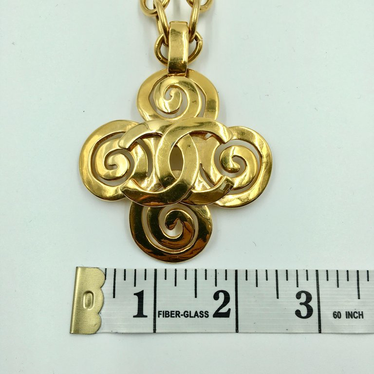 Chanel Gold Tone CC Logo Swirl Cross Necklace